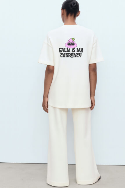 RahRaha Urban Chill White T-Shirt for Women – Back featuring “Calm Is My Currency” slogan and pink RahRaha chill character